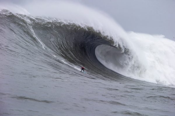 Surfer riding a large wave in the ocean